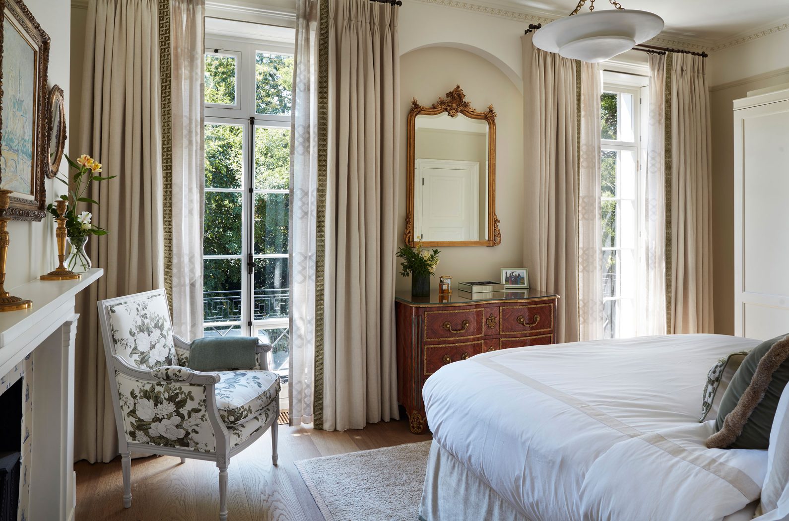 Luxury principal bedroom designed by Studio Indigo with large traditional floor to ceiling windows