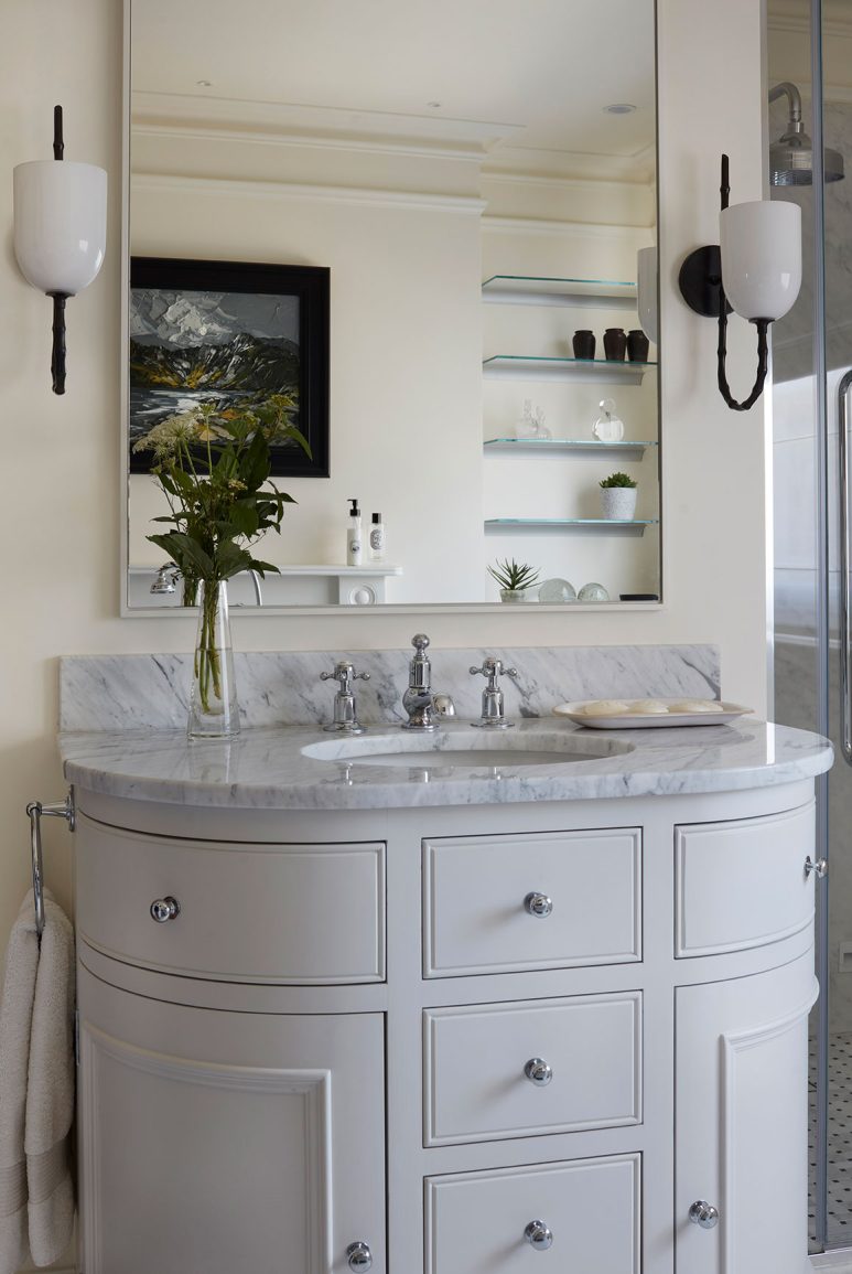 Curved sink basin with storage and mirror reflecting storage and art