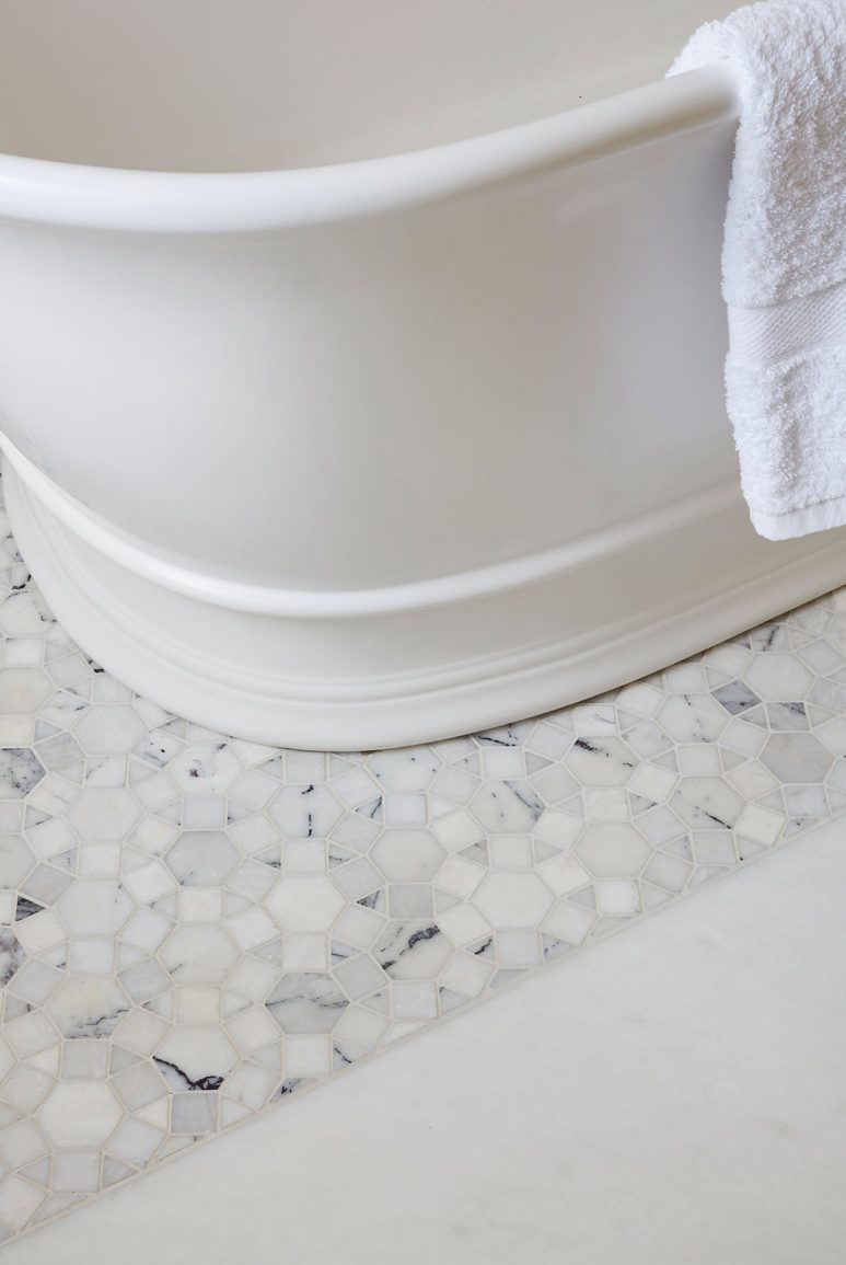 Neutral mosaic tiled floor detail in bathroom