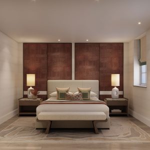A primary bedroom with pops of burgundy and green designed by Studio Indigo