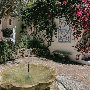 a courtyard with a fountain in Marbella - captured by Studio Indigo